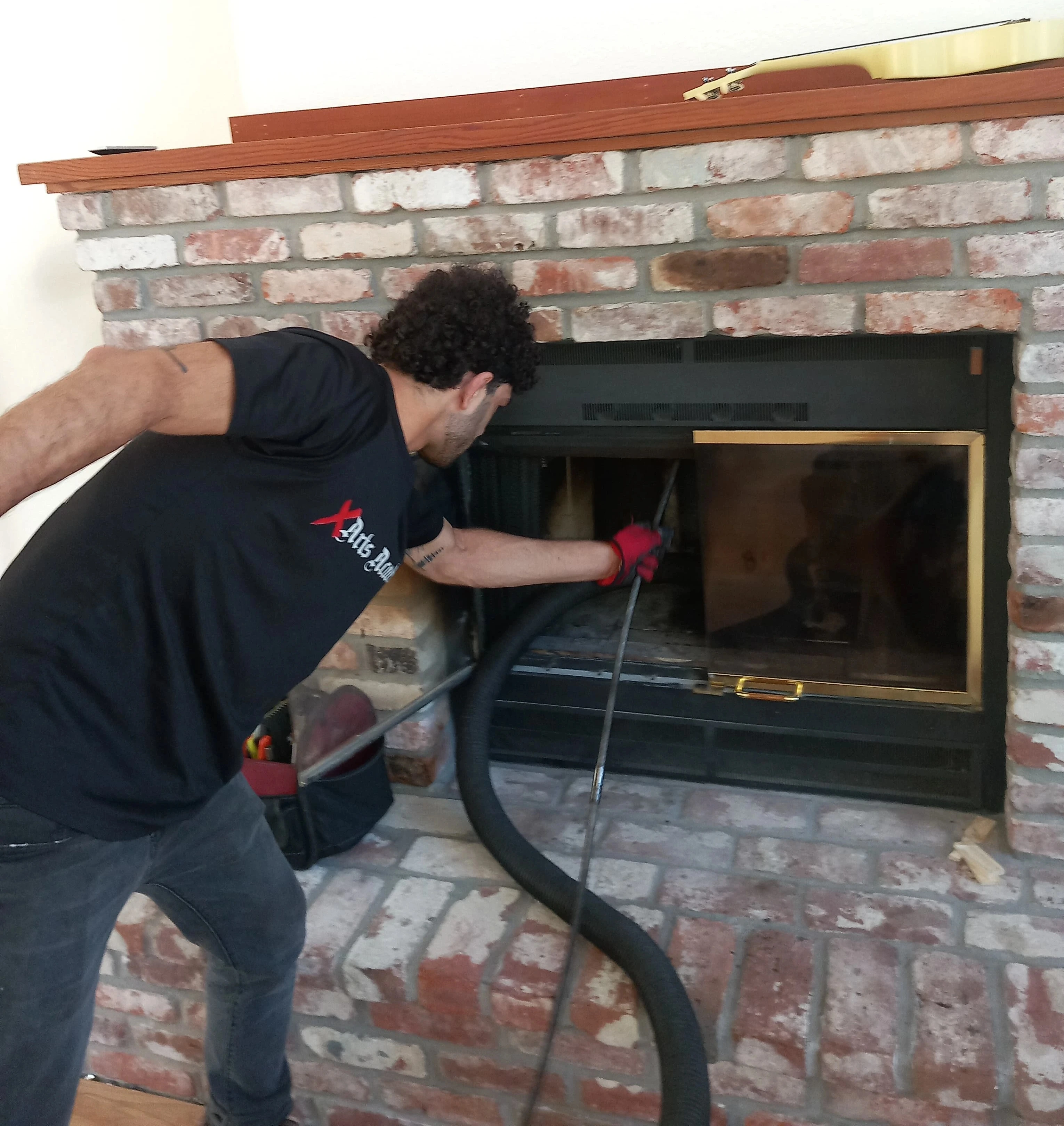 Chimney Guys INC certified technician performing a chimney sweep in Carmichael CA