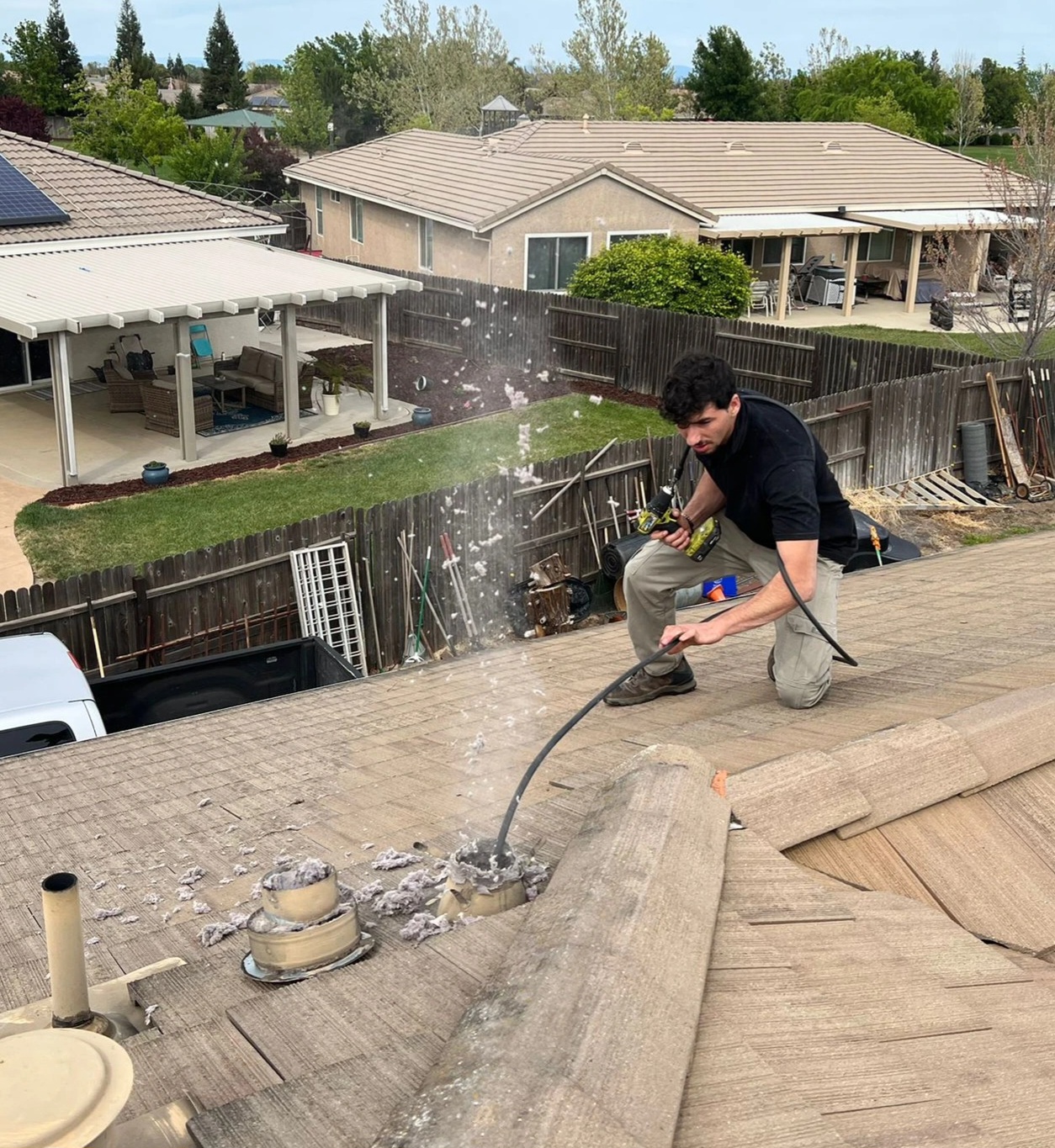 Chimney Guys INC technician cleaning a dryer vent duct in a Carmichael CA home